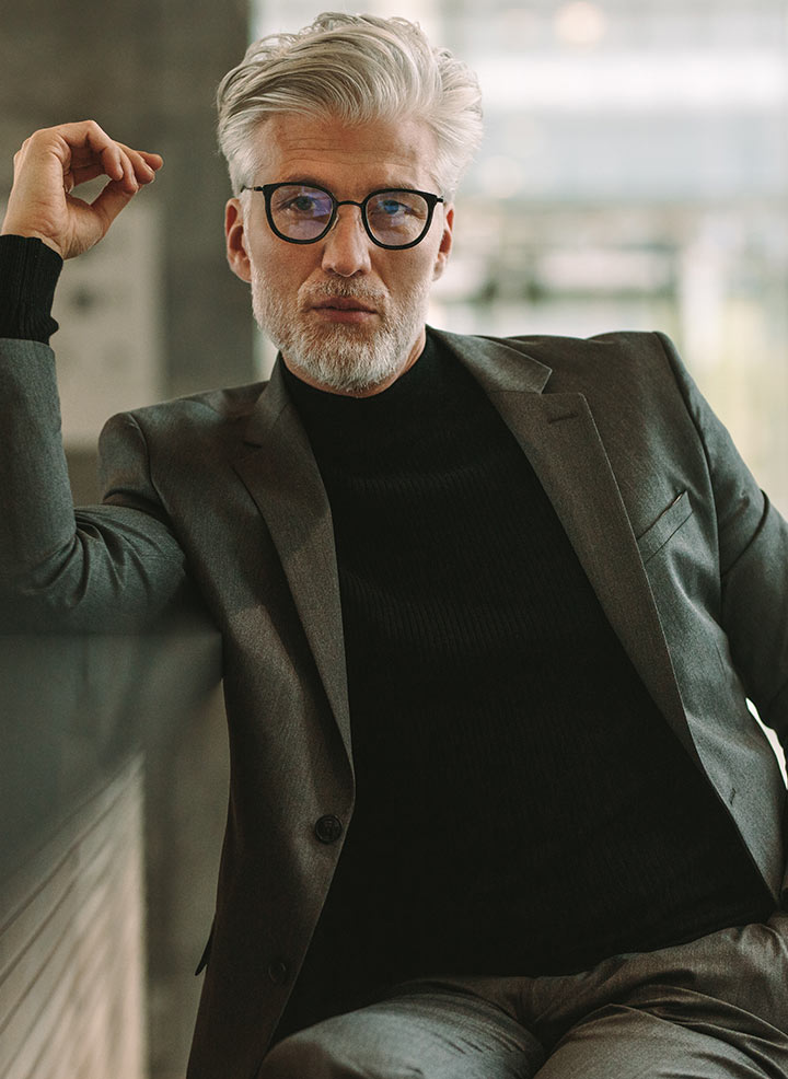 Man with glasses posing.